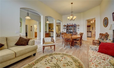 Great room towards kitchen at right and foyer and 
