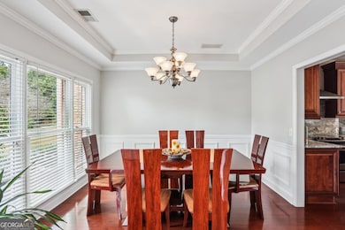 Huge dining room with wainscoting and tray ceiling