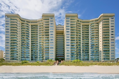 View of building exterior with view of water and beach