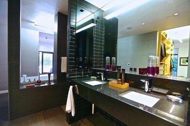 Bathroom featuring vanity with extensive cabinet s
