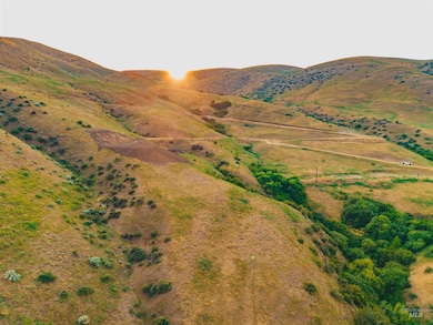 View of mountain backdrop with rural landscape