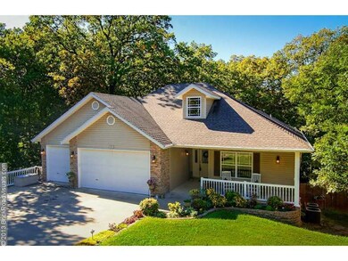 Exterior Front. Beautiful home nestled in the picturesque woods of Bella Vista!