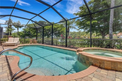 View of swimming pool with a pool with connected hot tub and glass enclosure