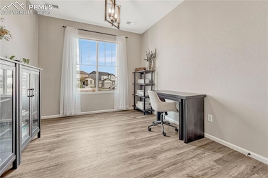 Home office featuring natural light and stylish ch