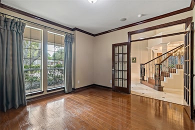 This handsome study is tucked behind elegant Frenc