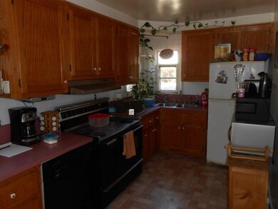 Equipped kitchen with oak cabinets.
