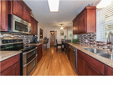 Spacious kitchen with wood floors & stainless stee
