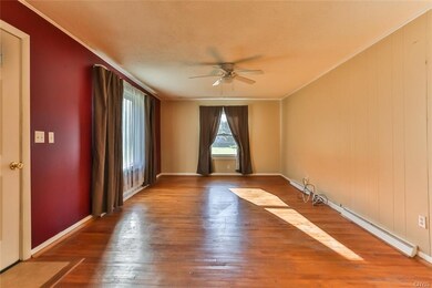 Enter into the spacious living room with hardwood 