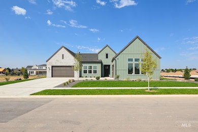 Modern inspired farmhouse with board and batten siding, concrete driveway, and a front yard