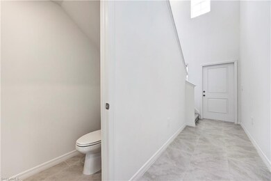 Bathroom featuring vaulted ceiling and tile patterned floors