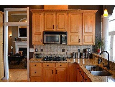 Kitchen. Eat in kitchen with granite, custom cabinets, breakfast bar, and gas cook top.