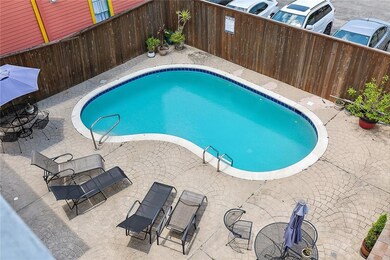 A VIEW OF THE GLIMMERING POOL FROM THE 2ND BEDROOM