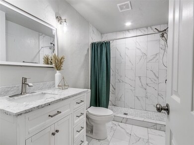 Bathroom with vanity, curtained shower, tile floor