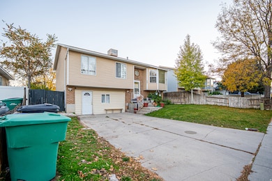 Back of house with a patio area, brick siding, and a chimney