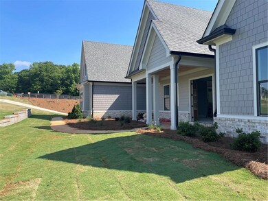 View of property exterior with a shingled roof