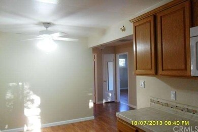Dining area with ceiling light and fan.