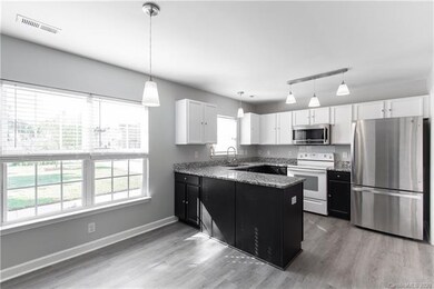 Dining area with great natural light and kitchen.