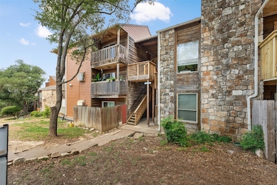 Back of property featuring stone siding, stairway
