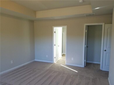 Unfurnished bedroom with carpet, a closet, a spaci