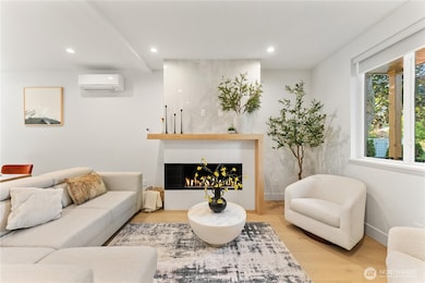 Main floor living room. Engineered hardwoods throughout the entire house. Window to the right looks out on the covered front porch.