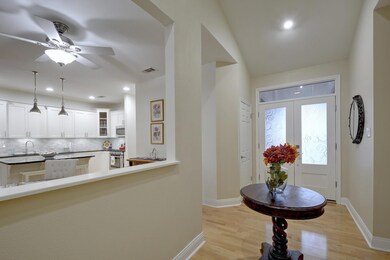 Foyer entrance featuring baseboards, light wood-t