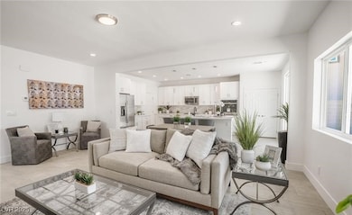 Living room featuring baseboards and recessed lighting