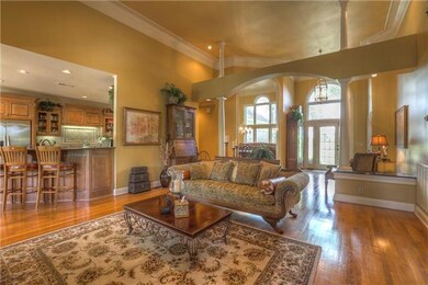 Soaring ceiling & open space make this a beautiful central living space. Imagine your lighted Christmas tree hovering in the corner. I'm sure it's breath-taking! Room also includes a large wet bar! 