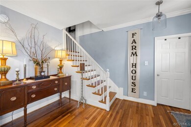 Foyer with dark wood-type flooring and ornamental