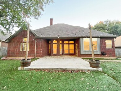 Back of property with a patio area and a yard