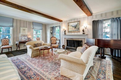 East wall in living room showcases beautiful brick fireplace (wood burning and gas), art lighting and sconces
