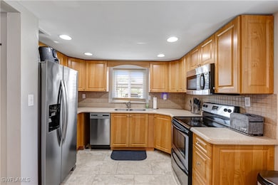 Kitchen with stainless steel appliances, a sink, l