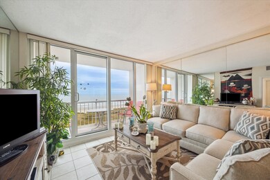 Living area enjoys floor-to-ceiling windows and do