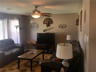 Amply sized living area with a bay window. (update