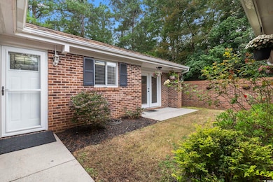 Entrance to property with a lawn