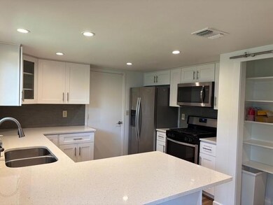 Kitchen featuring stainless steel appliances, lig