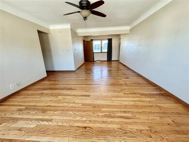 Living room with beautiful hardwood floors through