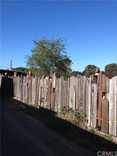Hand crafted fence with pottery in cutouts.