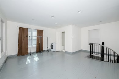 Spare room featuring baseboards, wood finished flo