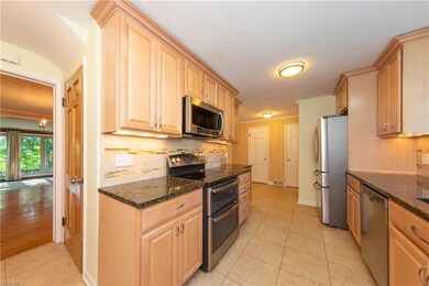 The remodeled Kitchen, with stainless steel appliances, has tons of natural wood cabinetry for all your storage needs.
