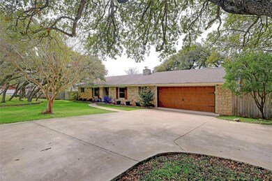 Ranch-style house featuring a garage, driveway, a