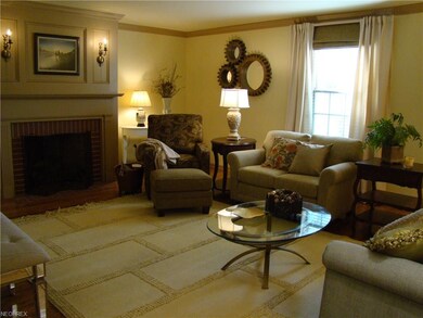 Family room with classically designed fireplace wi