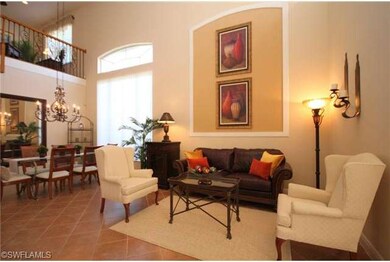 Living room and formal dining area with loft above