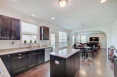 The kitchen features stainless steel appliances, a dual-basin sink, gas cooktop and dual built-in ovens.