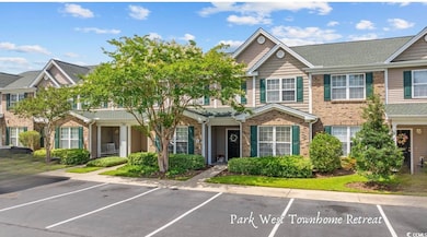 Traditional home with uncovered parking, a shingled roof, and brick siding