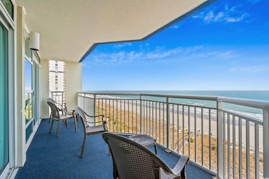 Balcony featuring a beach view and a water view