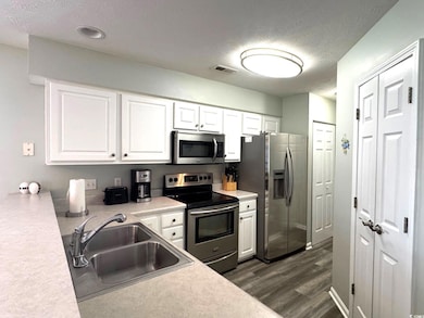 Kitchen featuring visible vents, appliances with s