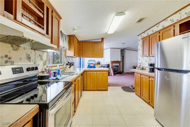Kitchen with stainless steel appliances, wallpaper