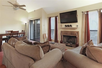 Living room with wood burning fireplace and dining