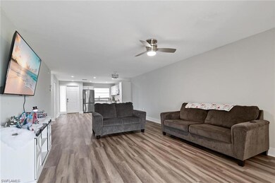Living room featuring ceiling fan and hardwood / w