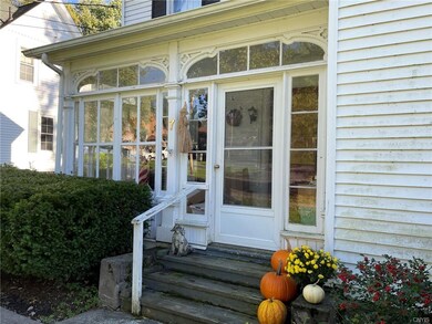 Enclosed front porch with custom woodwork and orig